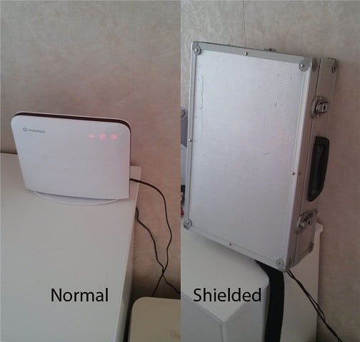 WiFi router with signal attenuated by a metal briefcase